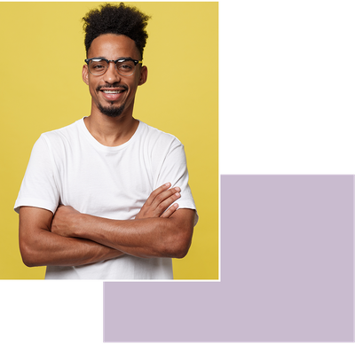 Man in glasses smiling in front of yellow background