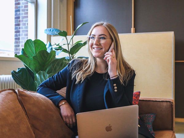 woman working on her laptop and cell phone