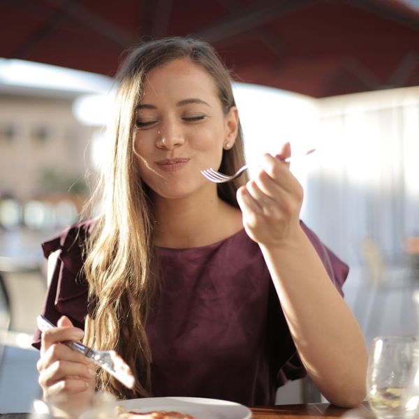A woman eating. A woman eating.