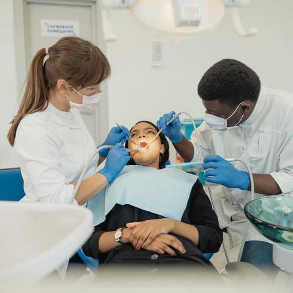 Two orthodontists and a patient. Two orthodontists and a patient.