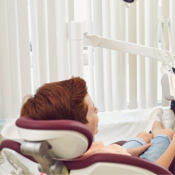 Boy in dental office chair.