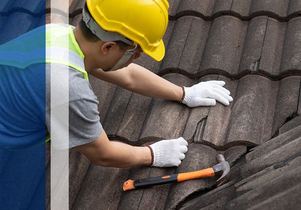 inspecting cracked tile roof