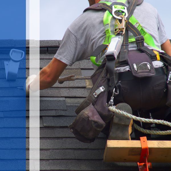 Worker installing shingle roof