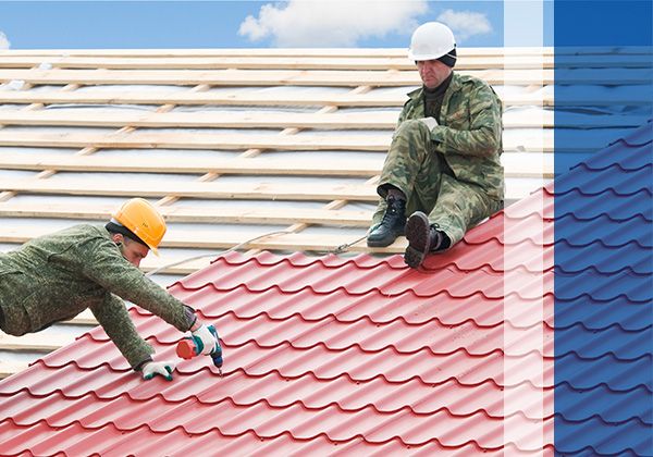 two workers installing metal roof
