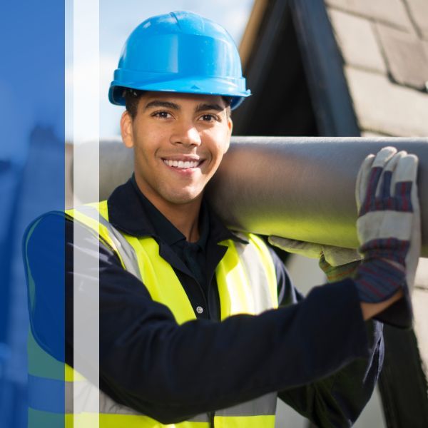 Roofer holding roof material and smiling