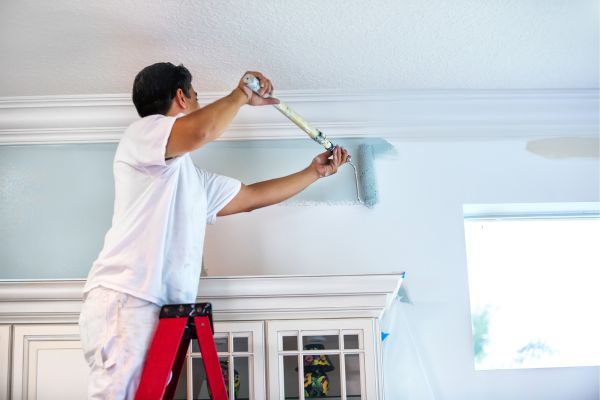 Professional painter painting the inside of a home. 