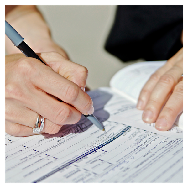 person filling out paperwork. 