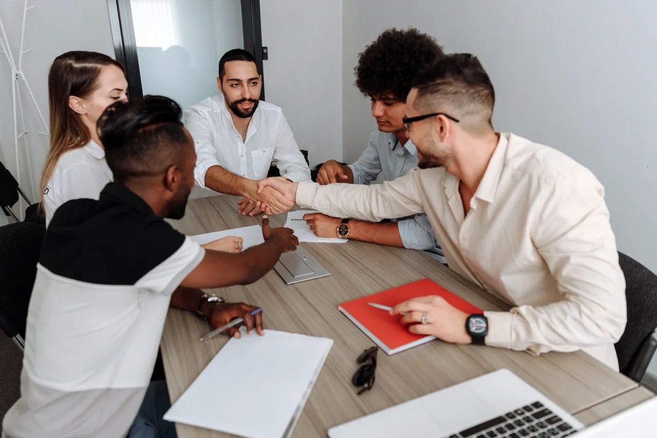 A meeting room with employees shaking hands