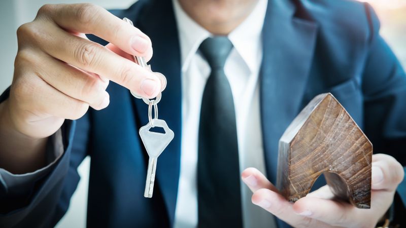 real estate agent handing key to client