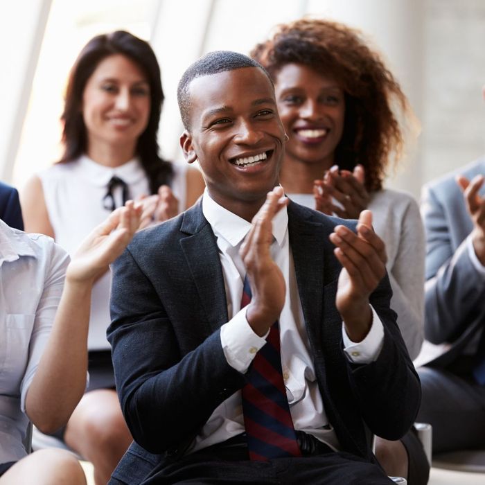 smiling man wearing suit clapping after speaker presentation smiling man wearing suit clapping after speaker presentation