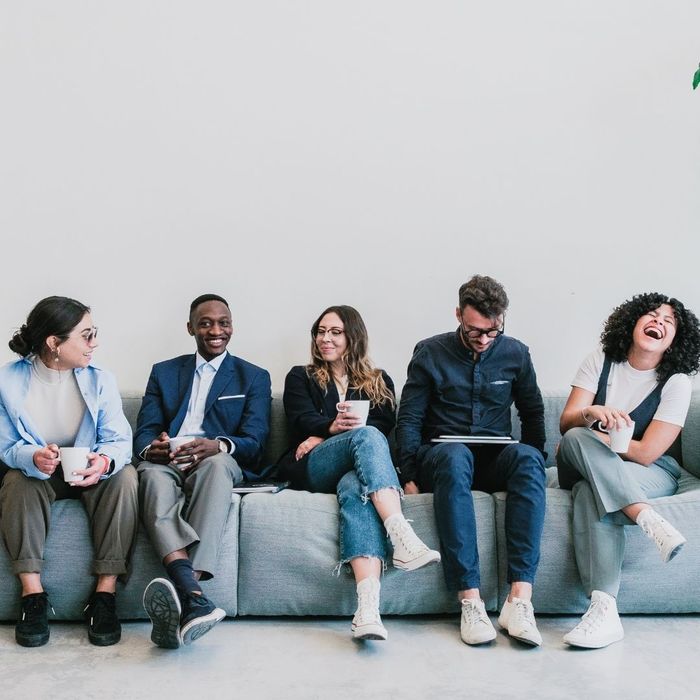 co-workers sitting on a couch talking
