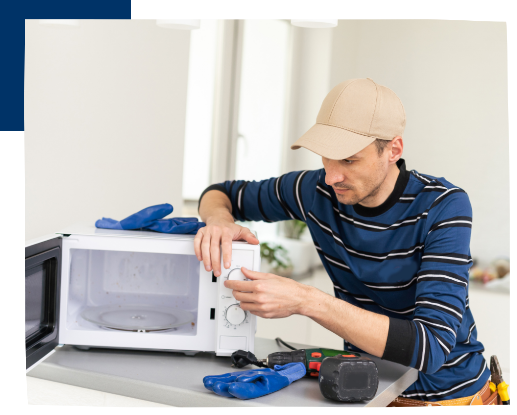 man repairing microwave