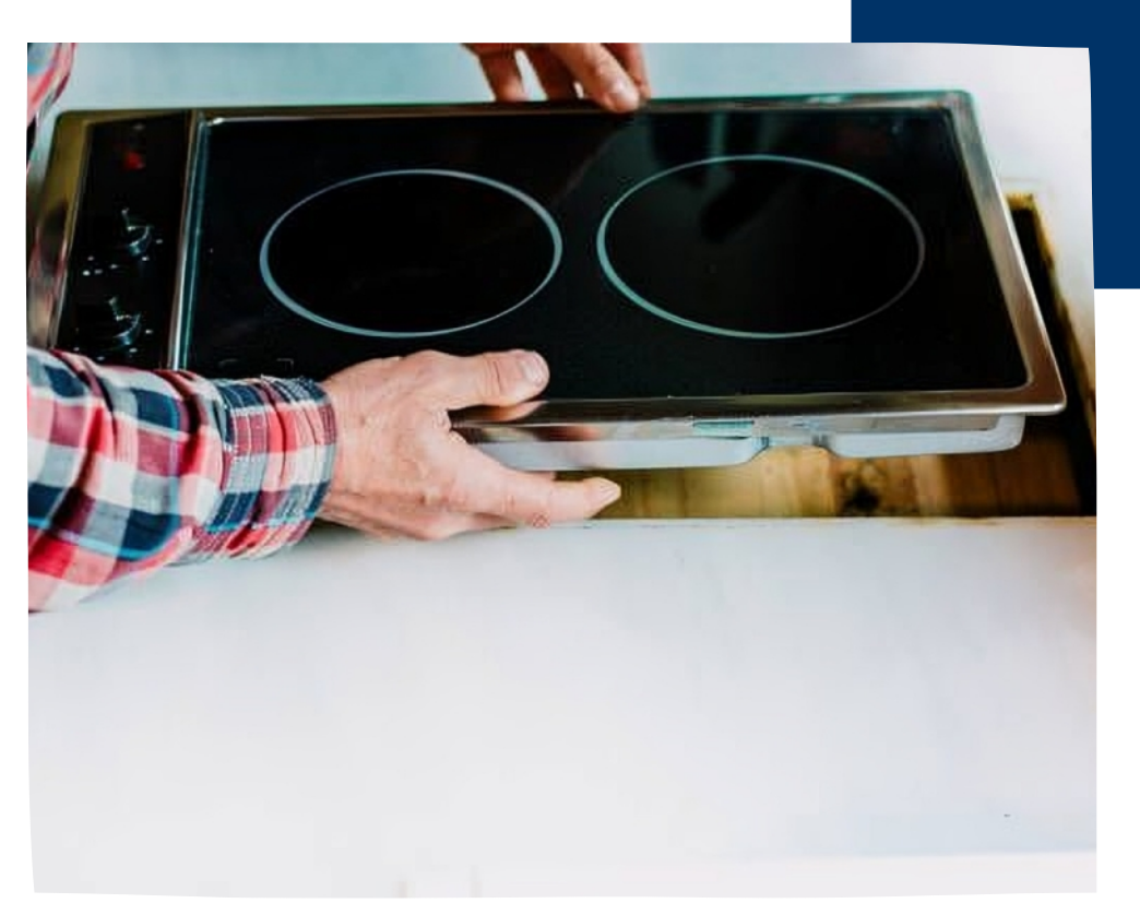 man installing cooktop