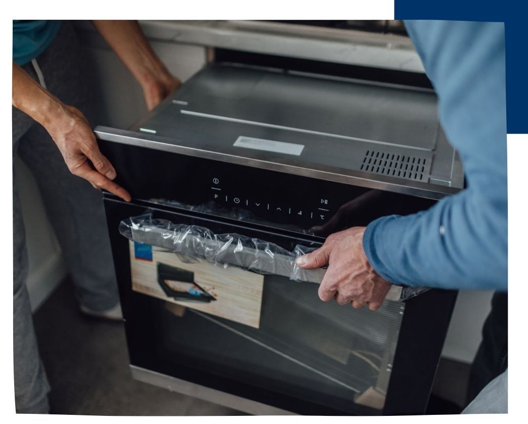 men installing new oven
