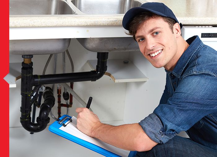 plumber with clipboard smiling