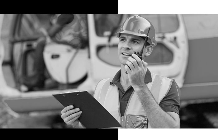 a construction manager on a portable radio