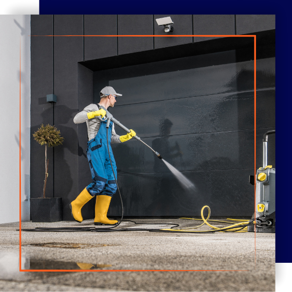 Soft washing black garage door and driveway.