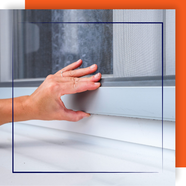 Contractor checking the fit of a window screen.