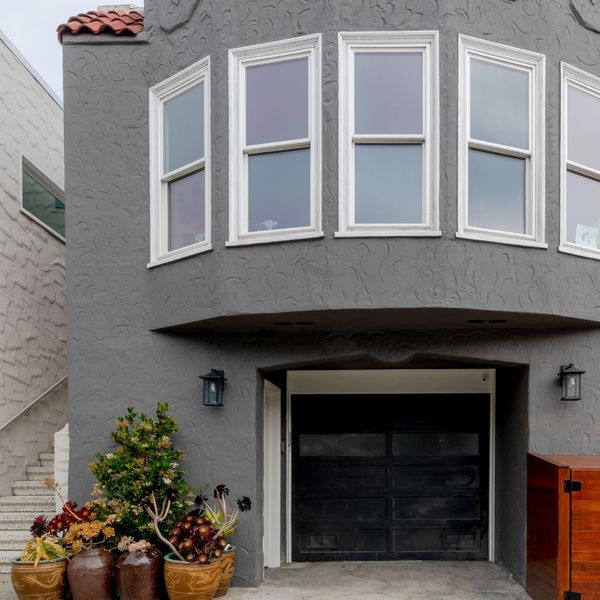 exterior of soft story garage with large bay window above