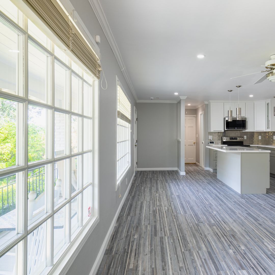 large windows into living area and open corner kitchen