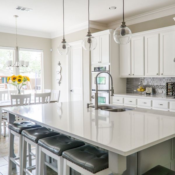 white kitchen with sleek island and lots of natural light