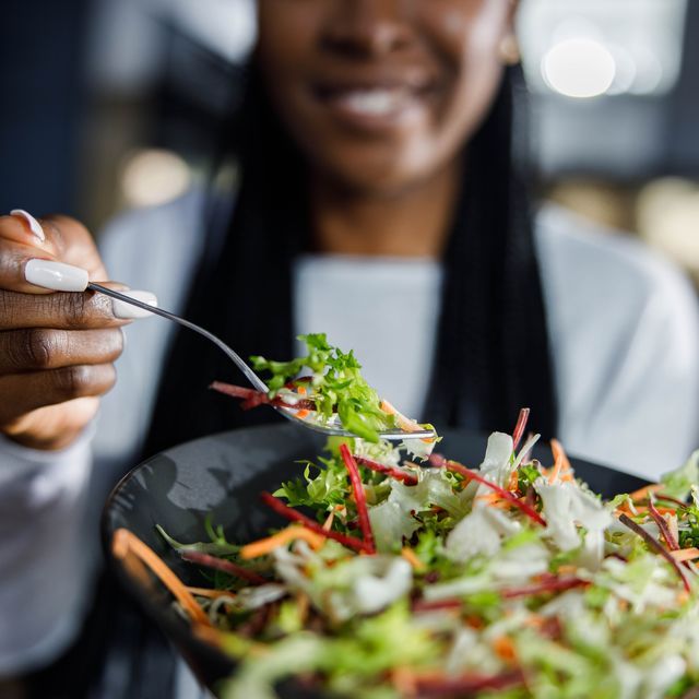 close-up-of-african-american-woman-with-fresh-salad-royalty-free-image-1701359184.jpg