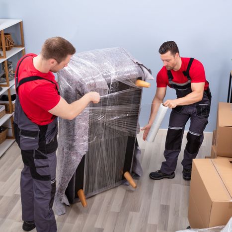 movers wrapping a couch