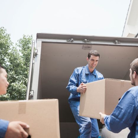 Movers handing each other boxes
