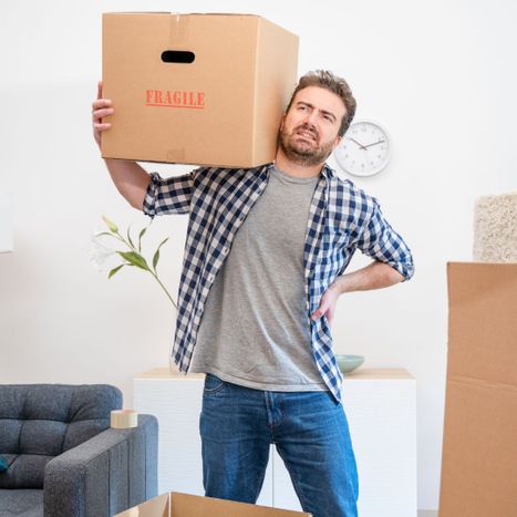 man resting a box on his shoulder