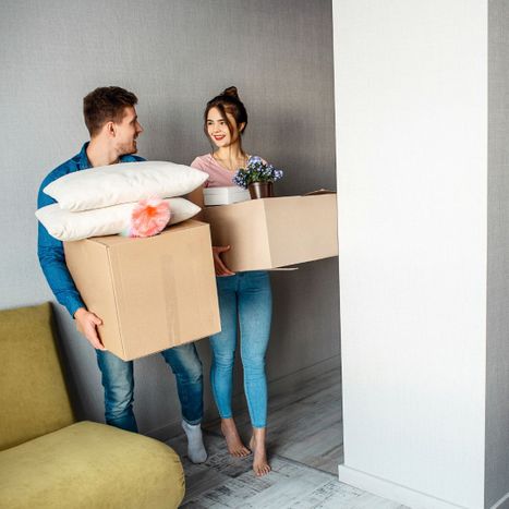 couple bringing boxes into home