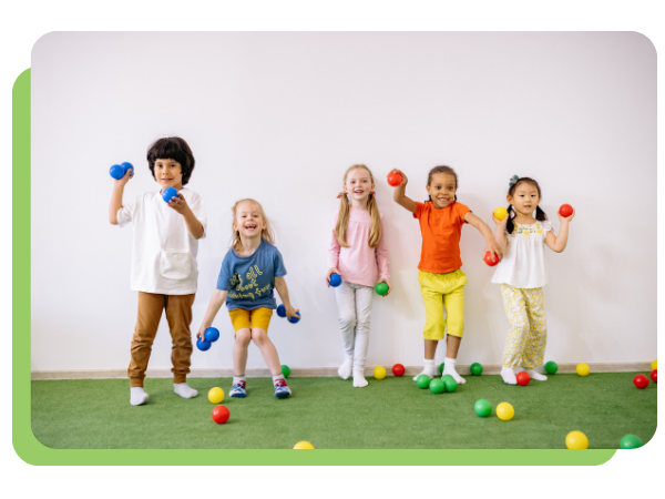 children standing in a line holding balls.