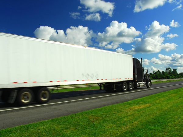 An image of a truck driving down a highway.