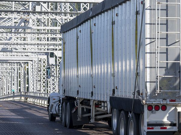 A truck driving across a bridge.