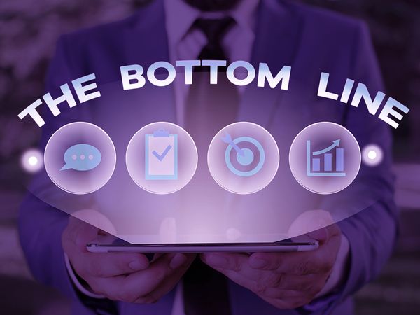 Business photo showcasing asking someone holding graphics that read “the bottom line”