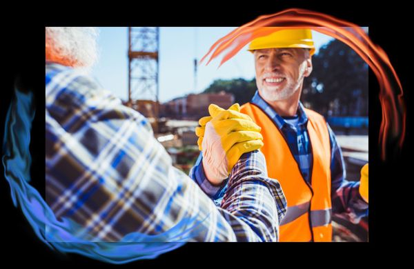 Two contractors shaking hands and smiling