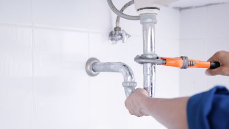 Someone fixing a leaking faucet