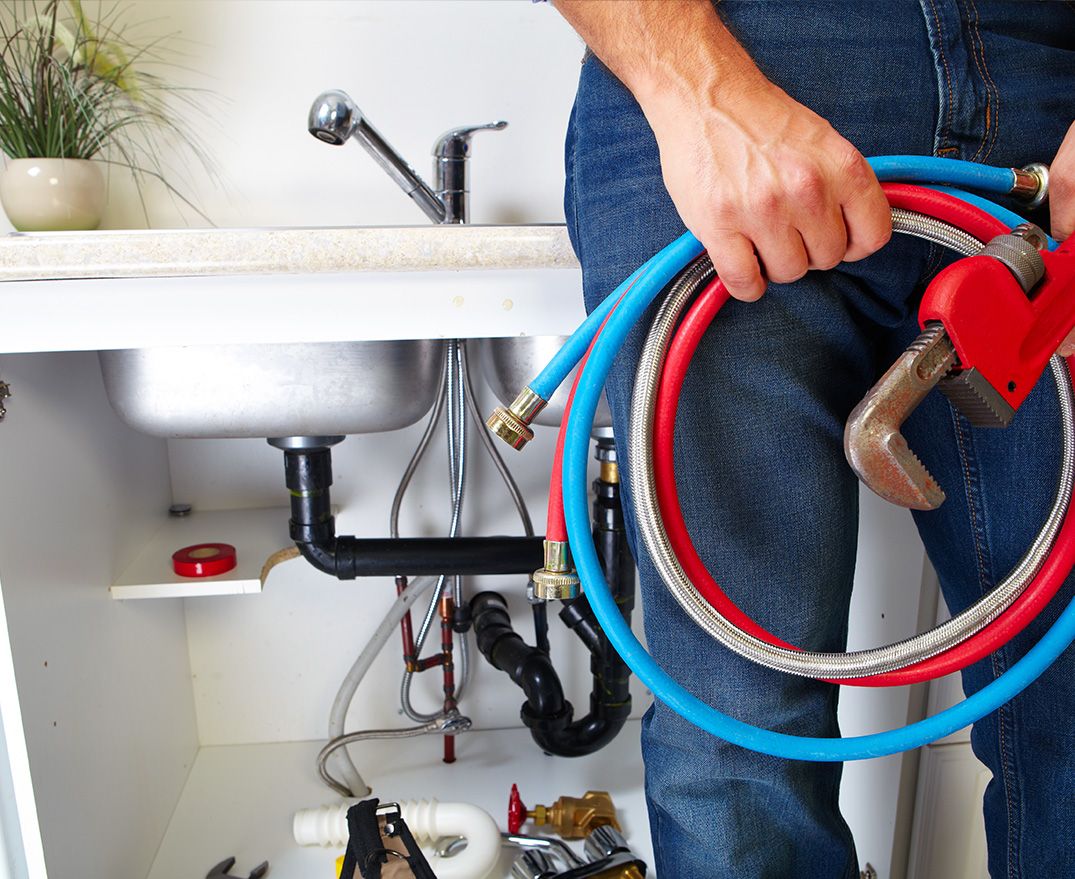 a plumber in front of sink