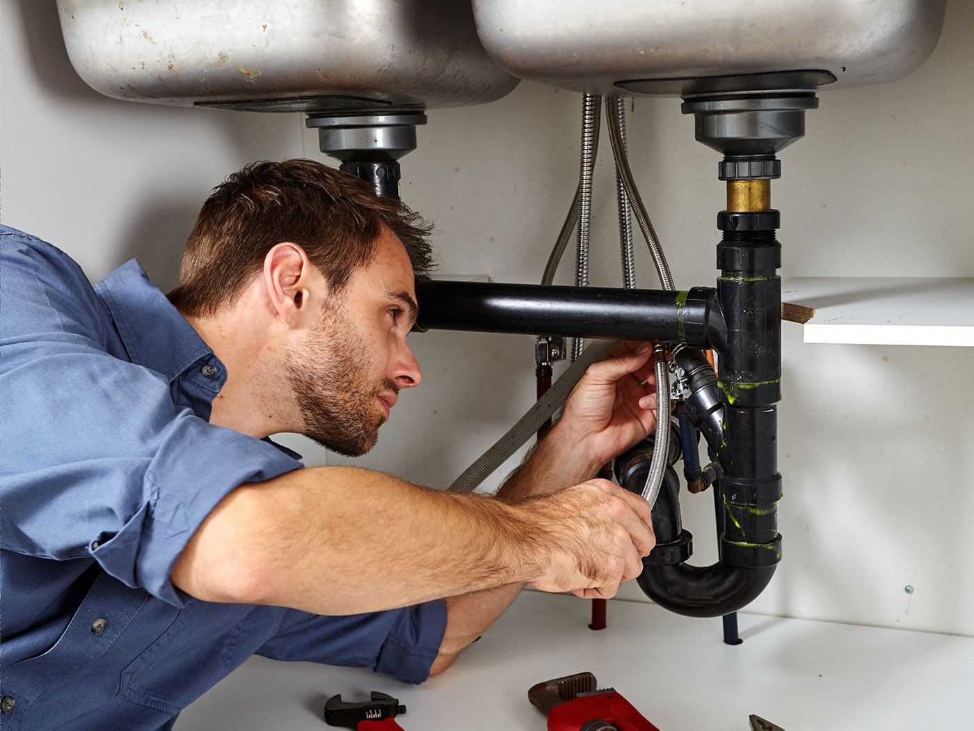 a professional plumber working on pipes