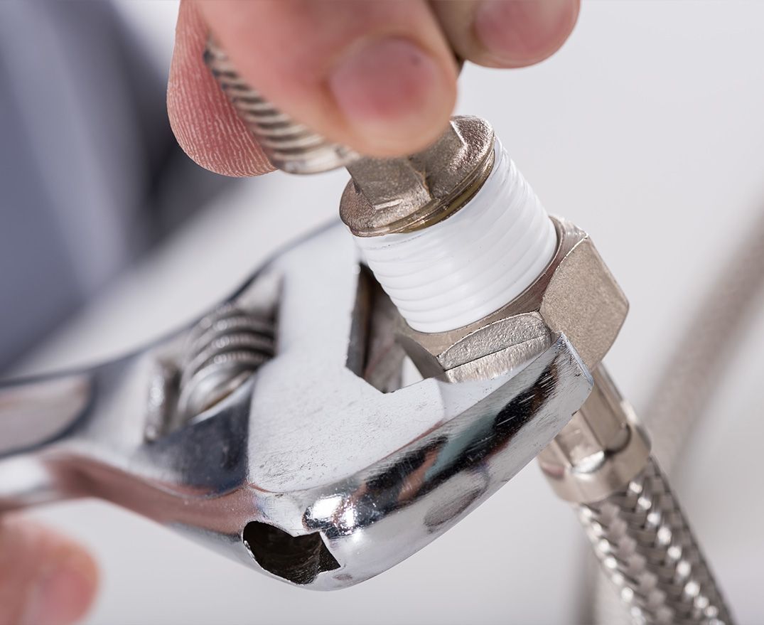 plumber using a wrench