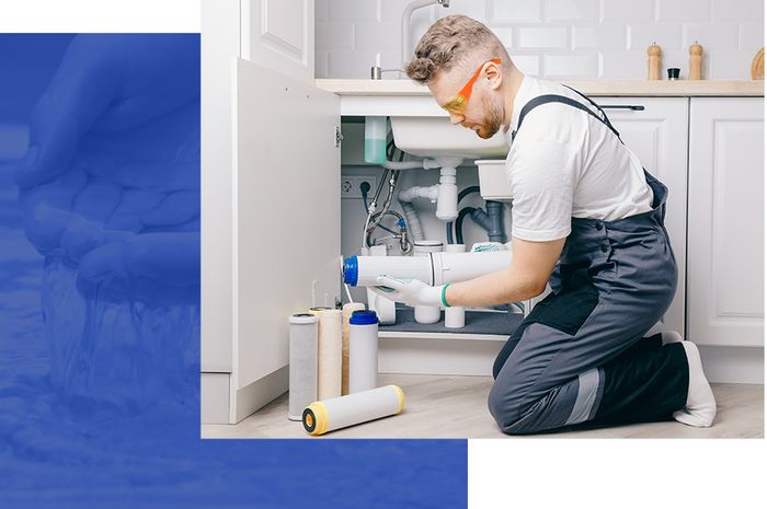 plumber installing under-sink water treatment system