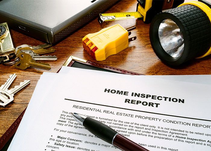 home inspection report on table with tools