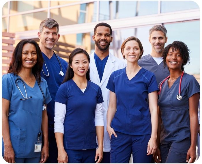 Group of hospital staff smiling for a photo