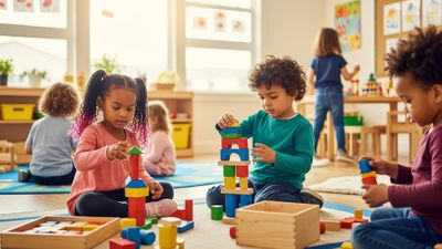 A diverse group of preschoolers playing with colorful wooden blocks in a bright classroom.