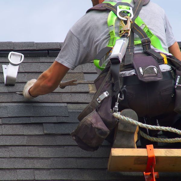 roofer working on shingle roof