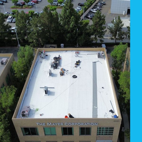 drone view of Precision team working on commercial roof