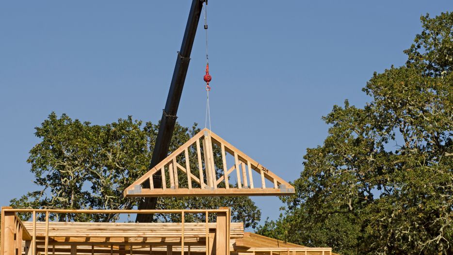 Truss being placed on a construction site
