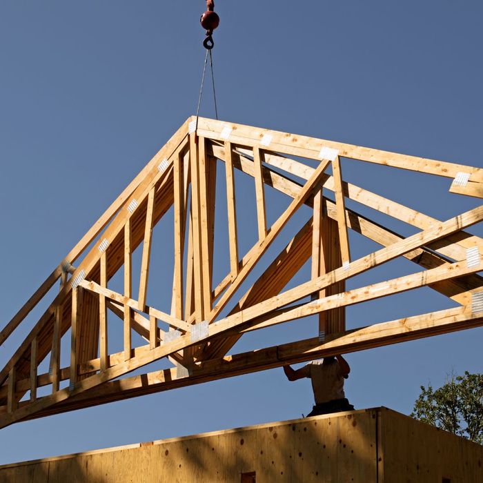 wood truss hanging from crane