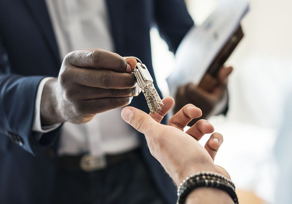 real estate agent handing a buyer house keys