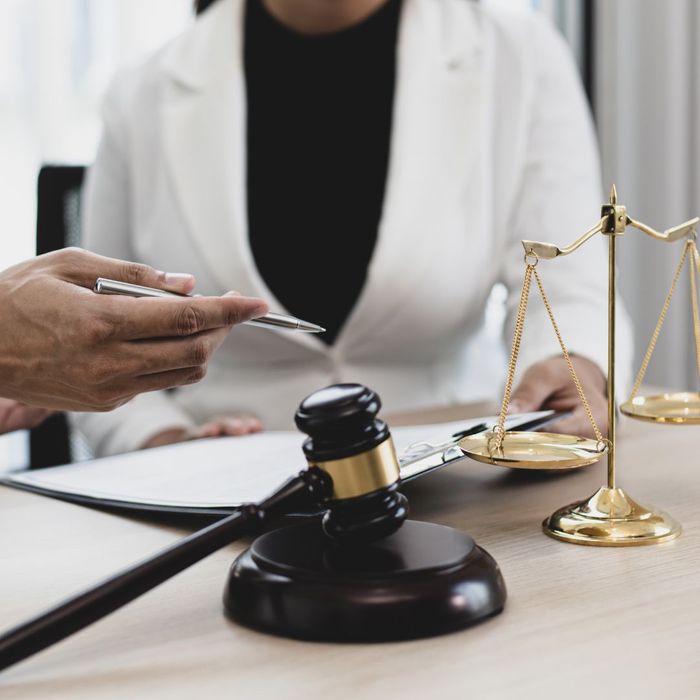 someone discussing matters with a lawyer with a gavel on the desk