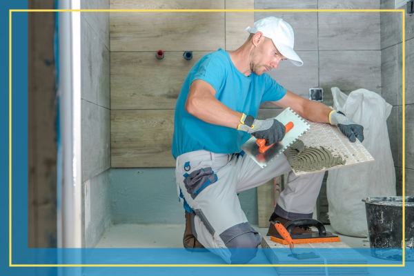 man installing bathroom tile. 